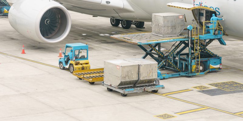 Loading platform of air freight to the aircraft. Food for flight check-in services and equipment to ready before boarding the airplane.